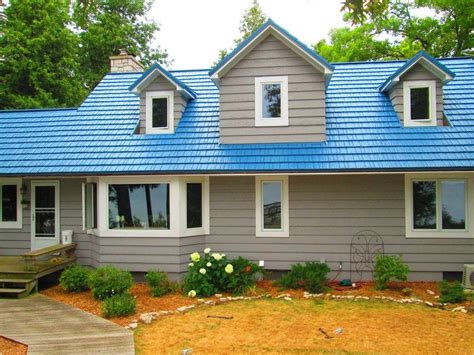 blue house with black metal roof|blue corrugated roofing.